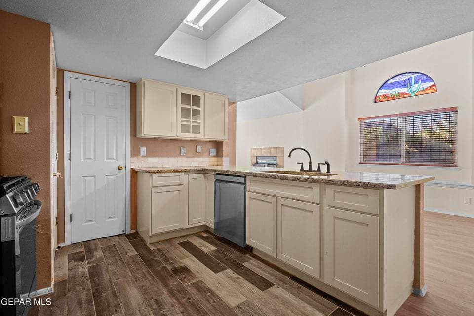 The kitchen offers a practical layout designed for everyday use. Ample counter space and cabinetry provide convenience and storage.