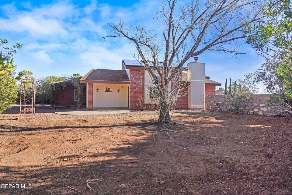 The walled backyard offers privacy and security. It provides space for outdoor relaxation or gatherings.