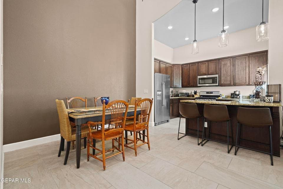 The vaulted ceiling, modern chandelier and access to kitchen make this a great space