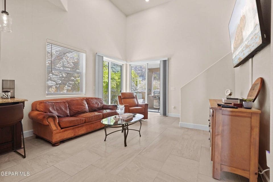 Boosting an open and airy feel, vaulted ceilings and double door backyard access