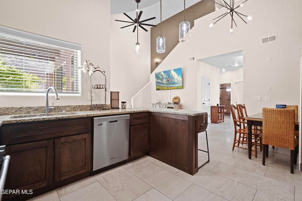 Stainless steel appliances and pendant bar light