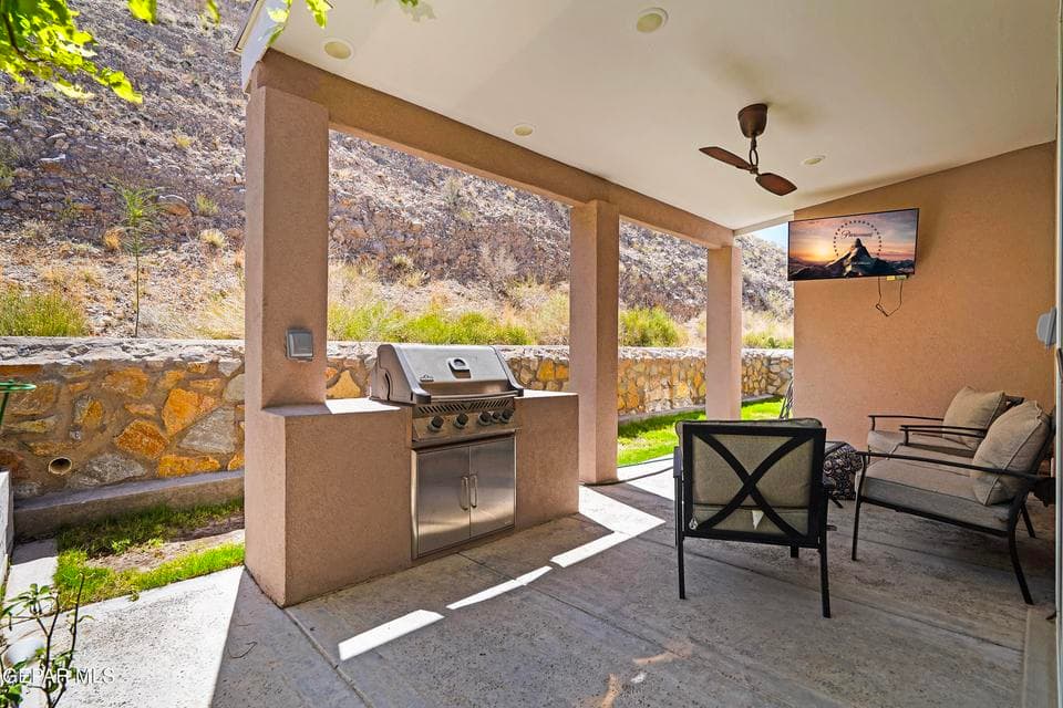 Custom built-in bbq space with tv and ceiling fan- great for after a long day