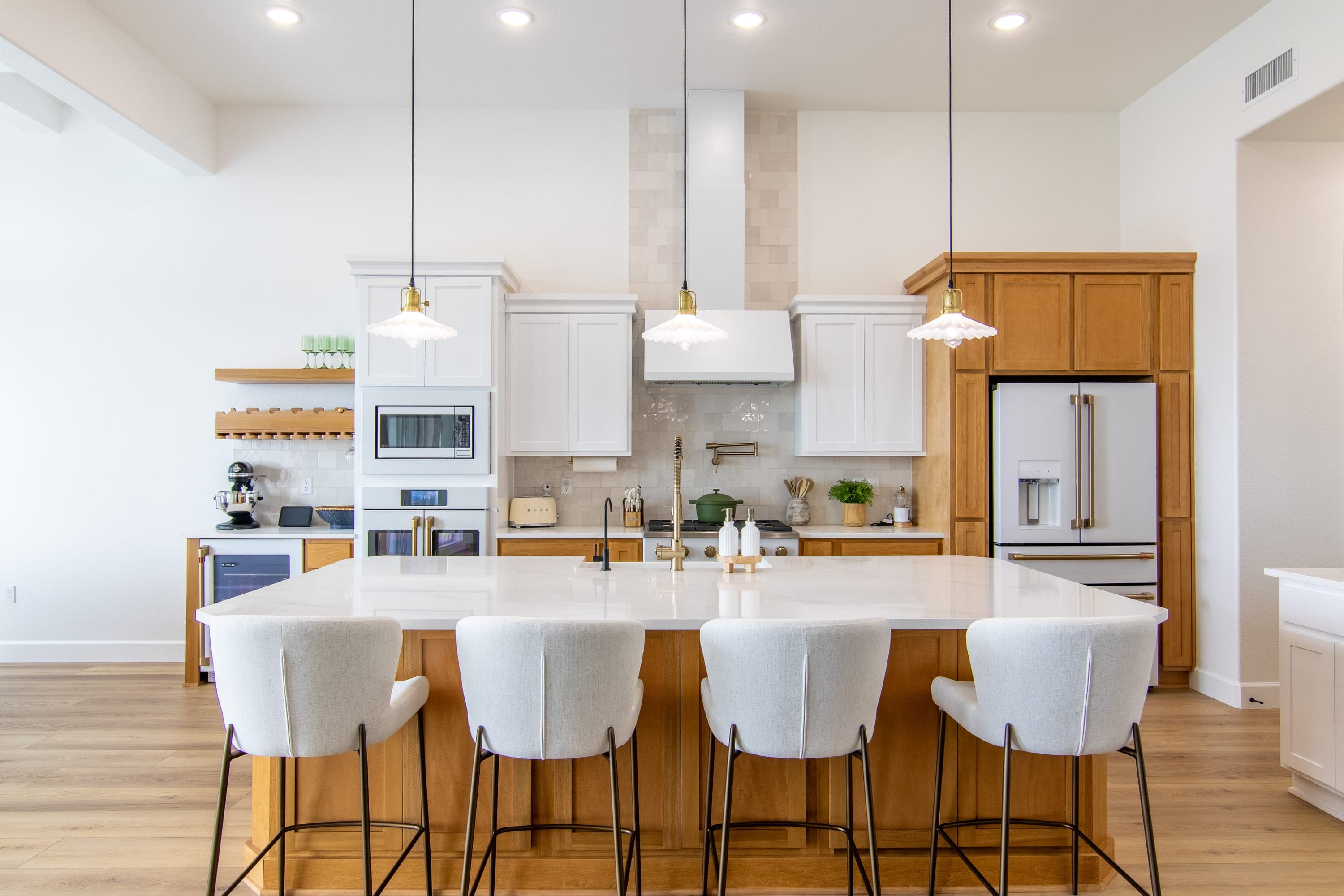 Bright open-concept kitchen with a large quartz island in an El Paso home
